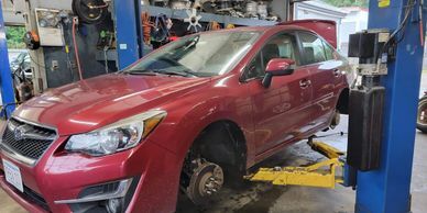 red car in servicing in a garage